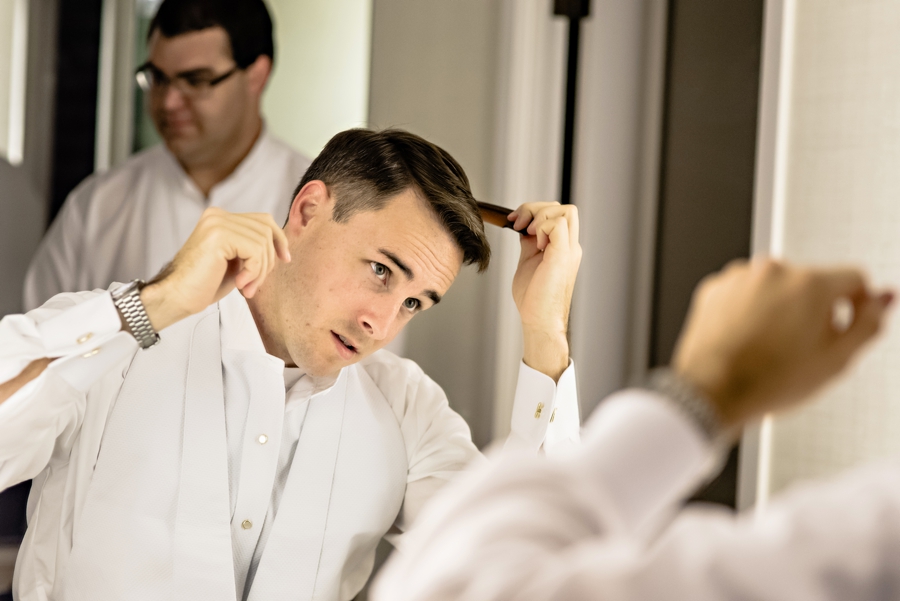 A groom getting ready at the Franklin Hotel before the ceremony.